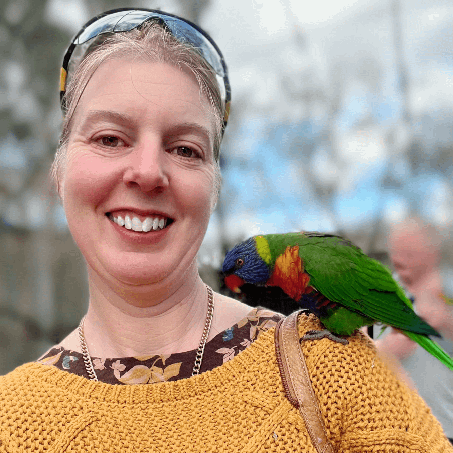 Smilingwoman with parrot on her shoulder